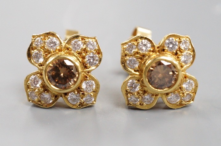 A modern pair of 750 yellow metal and two colour diamond cluster set earrings, 9mm, gross weight 4.1 grams, the central stone of a champagne/brown colour.